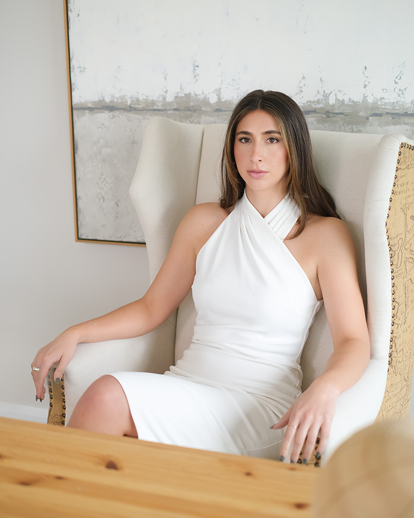 Real Estate agent sitting in white dress Newport Beach